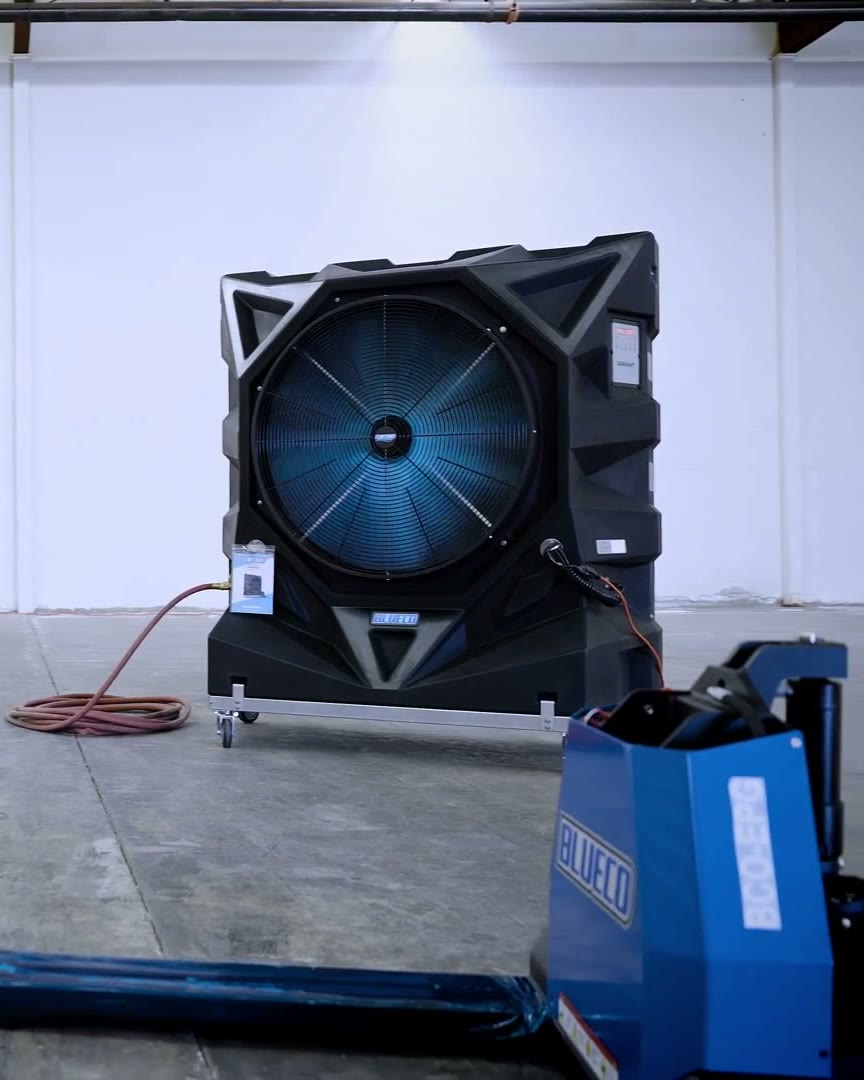 VARIANT-36 evaporative cooler in a bright warehouse, a BLUECO electric pallet jack in front