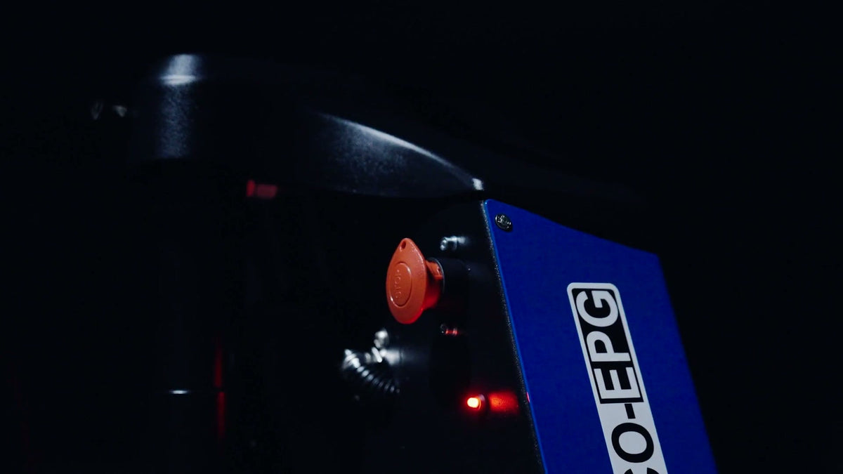 Electric pallet jack in a dark studio, its BCO-EPG cover and red lights up close