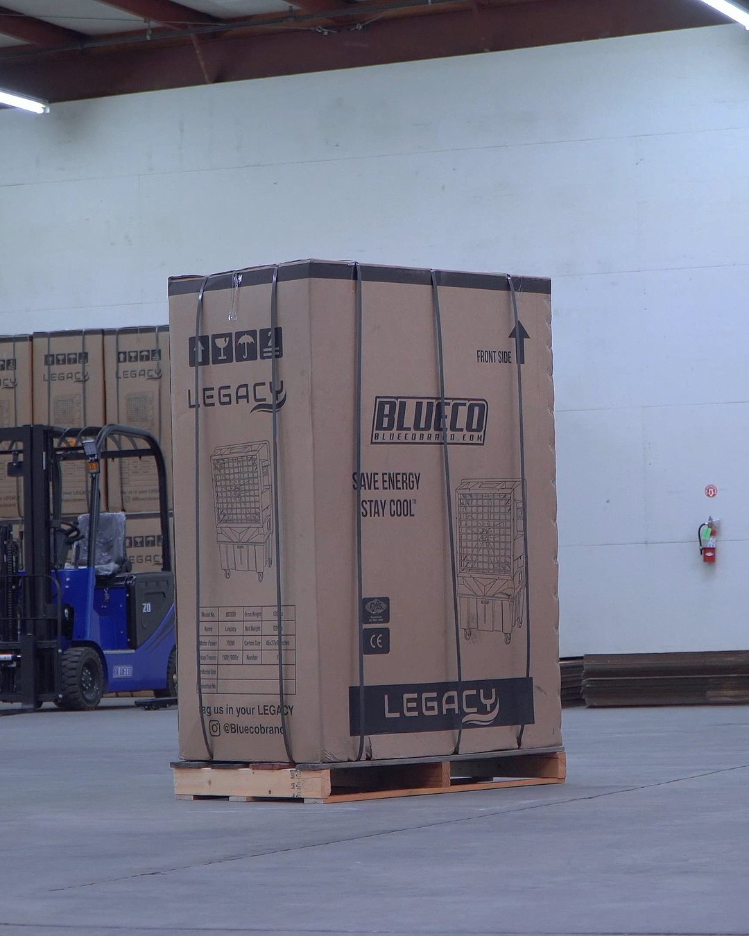 A boxed LEGACY-30 evaporative cooler on a pallet in a BLUECO warehouse