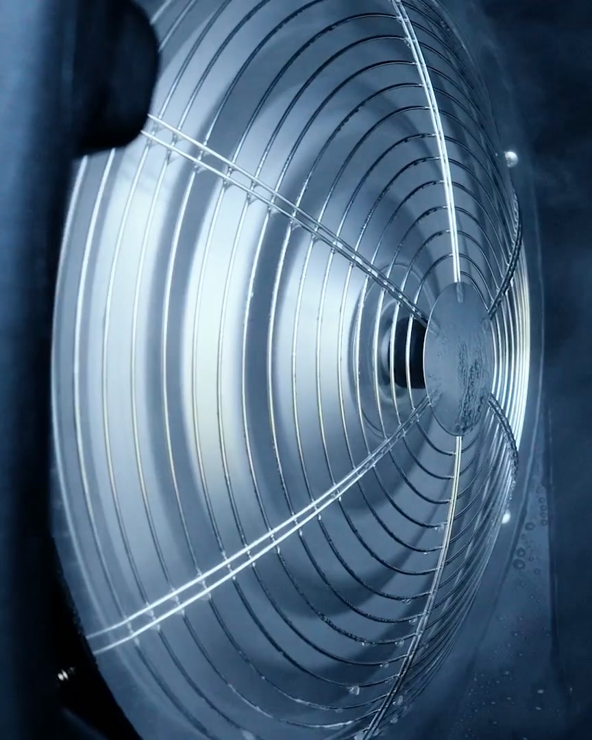 HydroBlu fan guard close-up with mist drifting past the blades