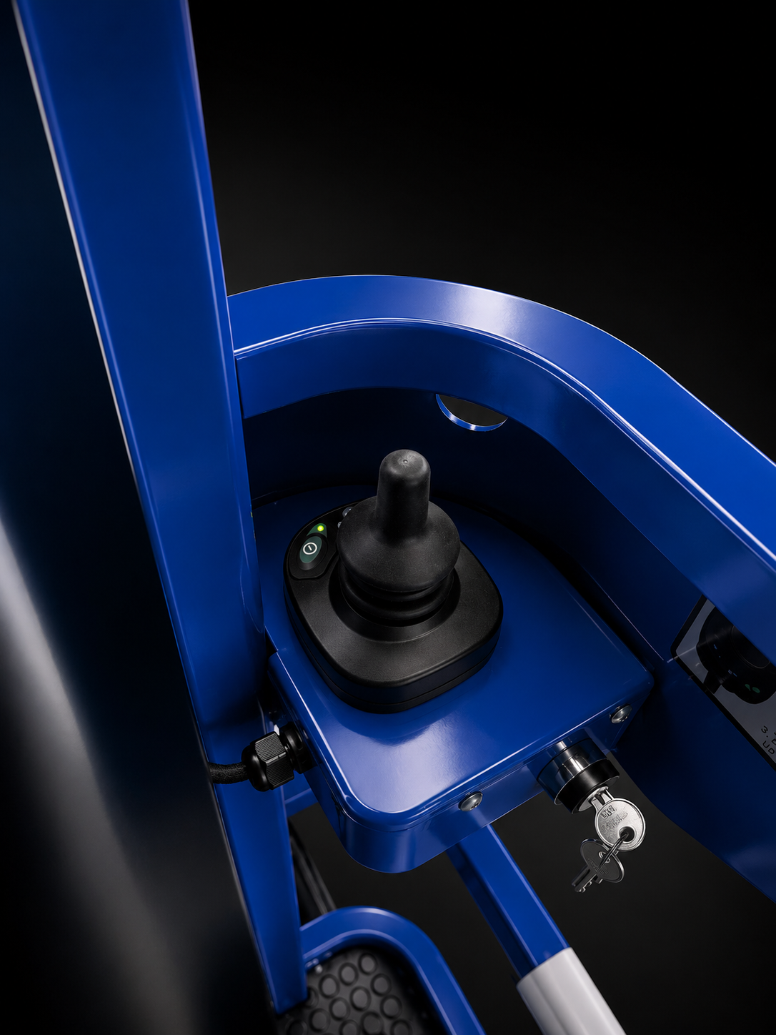 Order picker right-hand drive and lift joystick inside the blue operator compartment, on black