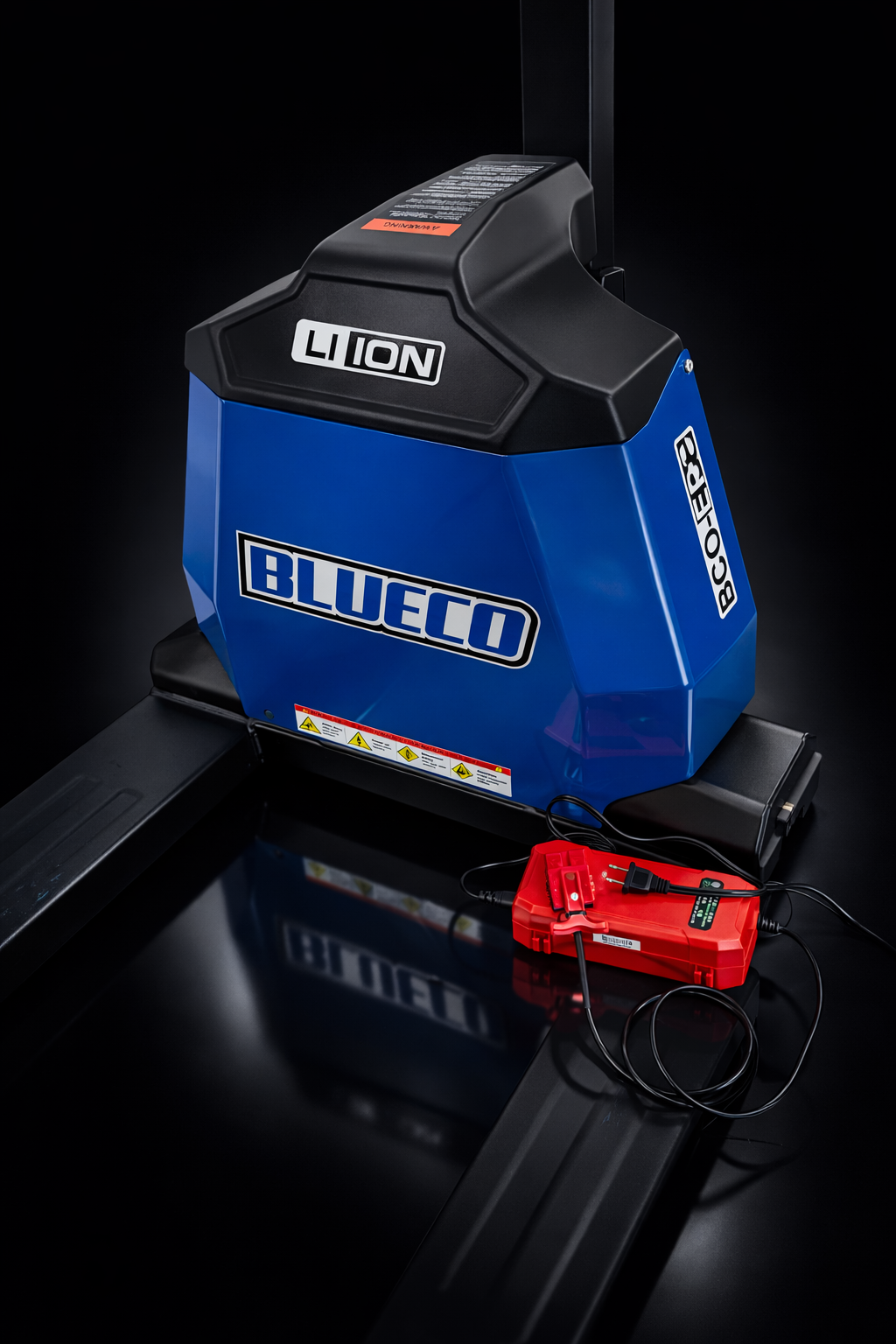 Electric pallet jack battery housing with its red charger plugged in, on black